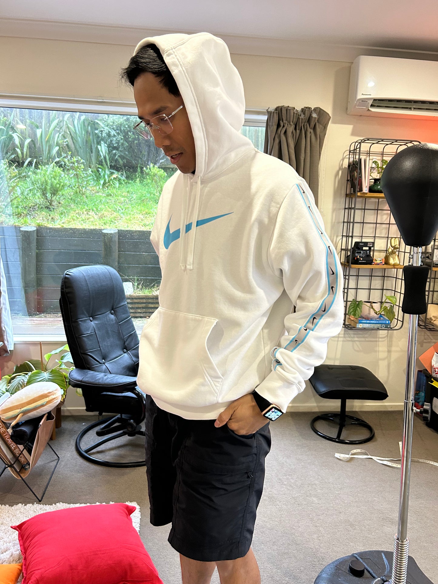 Nike Sportswear Repeat Fleece hoodie in summit white features distinctive Baltic blue branding on the chest and along the sleeves Medium