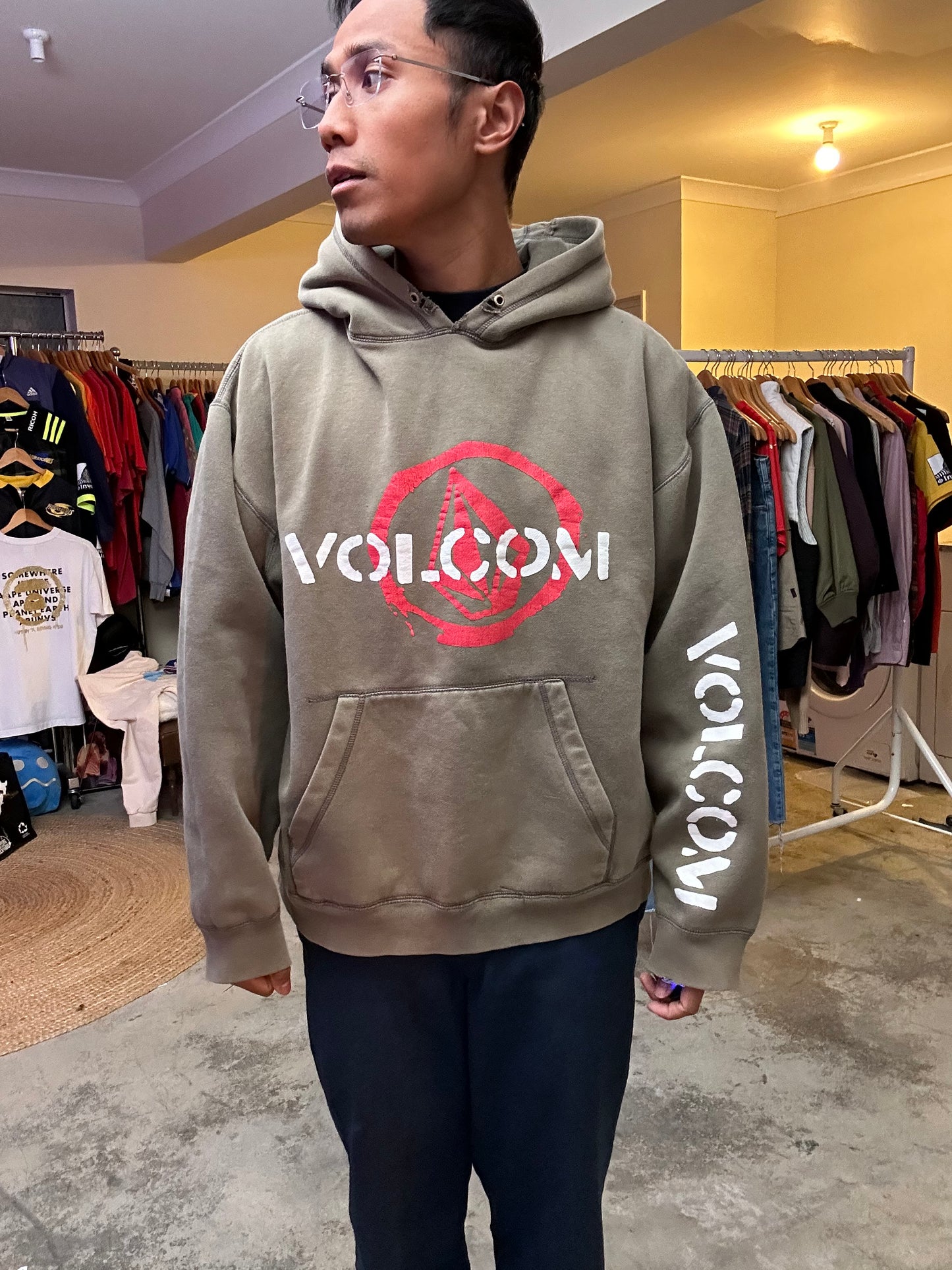 Vintage Y2K Volcom hoodie featuring a red and white graphic logo on the chest and text on the sleeve Army Green Faded