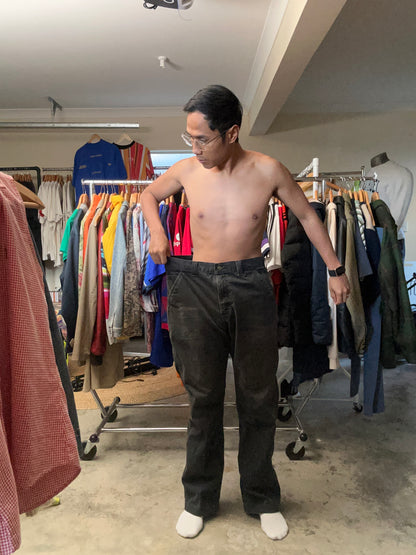 vintage Carhartt Carpenter pants, characterized by a faded black finish and utility features like a hammer loop size 36