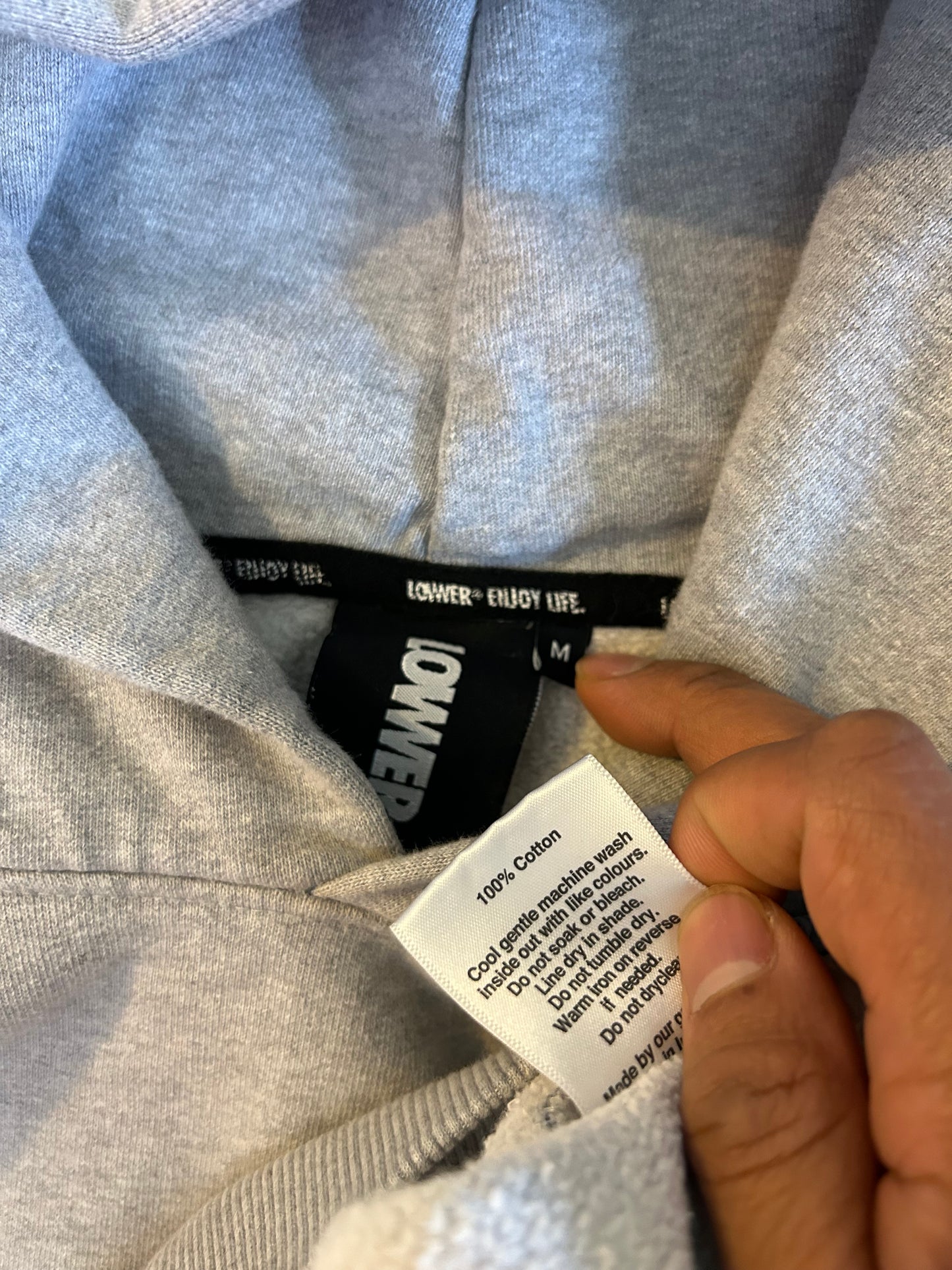 heather grey hoodie from Lower features a central "Lower" graphic of a hand on a vinyl record with star accents Medium
