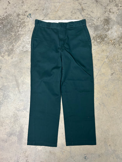 Vintage green Dickies 874 Original Fit Work Pants, recognized by their iconic tunnel belt loops and straight-leg cut 34