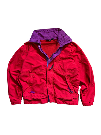 vintage Patagonia jacket, likely from the Fall Line collection, featuring a vibrant red shell and a purple collar Medium
