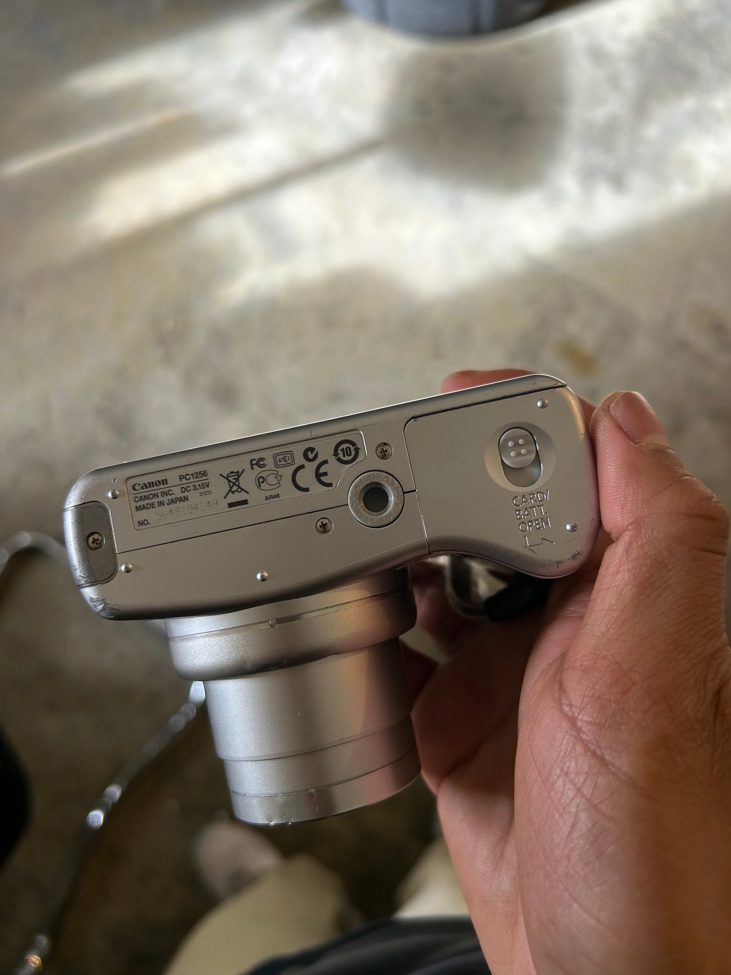 silver Canon PowerShot SX100 IS digital camera with a 10x optical zoom lens