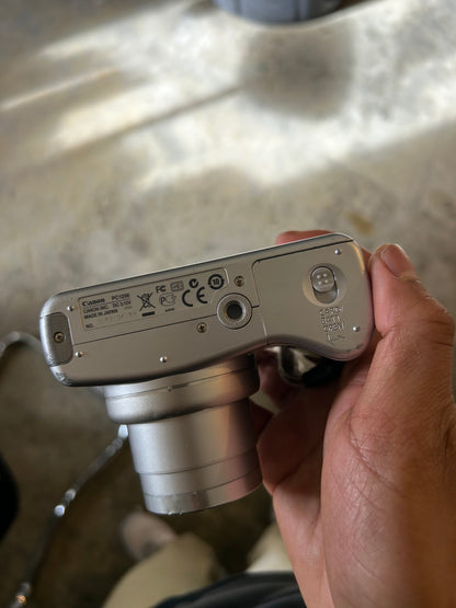 silver Canon PowerShot SX100 IS digital camera with a 10x optical zoom lens