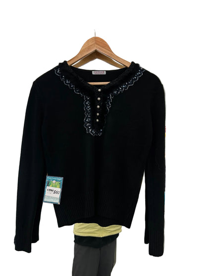 Yuyuan black long-sleeve sweater features a V-neckline adorned with delicate lace trim and pearl-like button details