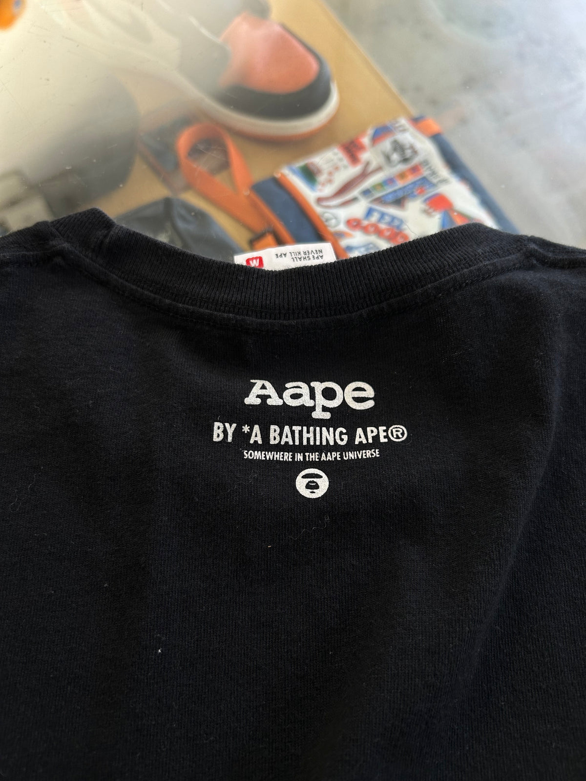 black AAPE by A Bathing Ape t-shirt featuring a vibrant rainbow gradient Ape Head logo on the chest Medium