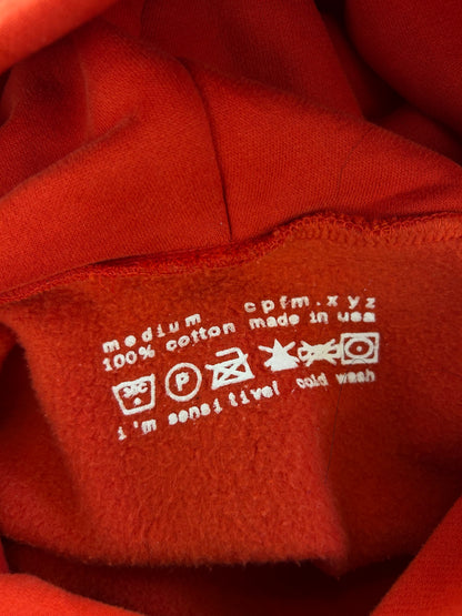 red Cactus Plant Flea Market (CPFM) "Ye Must Be Born Again" hoodie featuring prominent white puff-print lettering across the chest. Medium