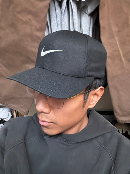 Vintage black Nike baseball cap featuring a white embroidered Swoosh Cotton