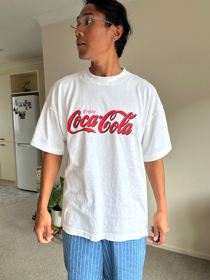 vintage white t-shirt featuring the classic red "Enjoy Coca-Cola" script logo Large