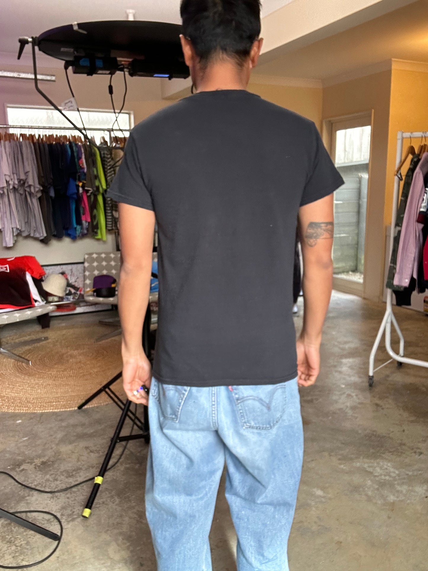Small black graphic t-shirt featuring the characters and logo from the 1996 film Space Jam