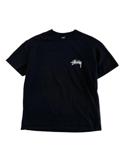 Stüssy Fuzzy Dice Tee in black, featuring a prominent fuzzy dice graphic on the back. Large