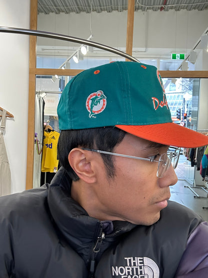 vintage Miami Dolphins snapback hat features a distinctive orange brim contrasting with a teal crown
