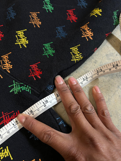 black, pullover-style hoodie featuring an all-over, multi-colored Stüssy logo print Small