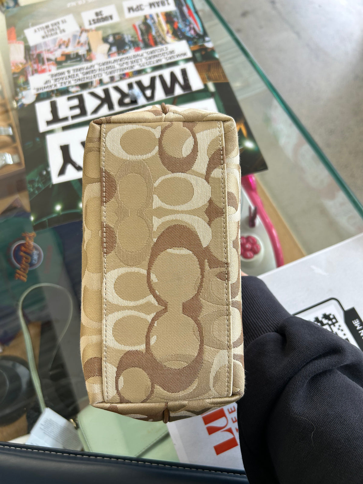 vintage Coach signature jacquard mini shoulder bag featuring the iconic brown "C" monogram pattern and a handy front pocket with a snap closure.