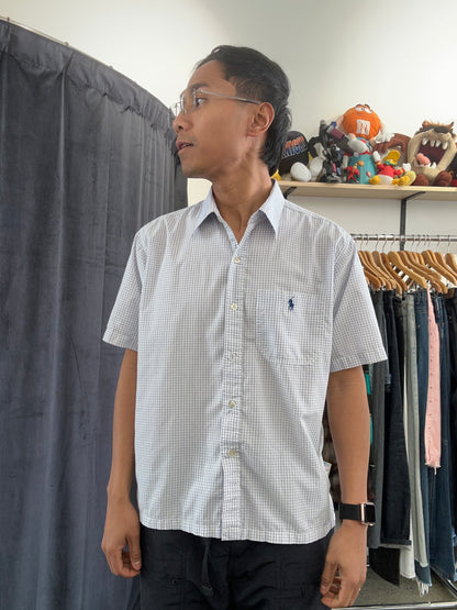 Vintage light blue and white grid-check (graph-check) short-sleeve button-down shirt by Polo Jeans Co. / Ralph Lauren featuring a small dark pony logo embroidered on the chest pocket.