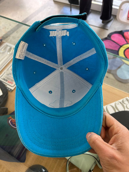 vintage 1999 M&M's Crispy "Orange" character advertising baseball cap in a vibrant turquoise blue.