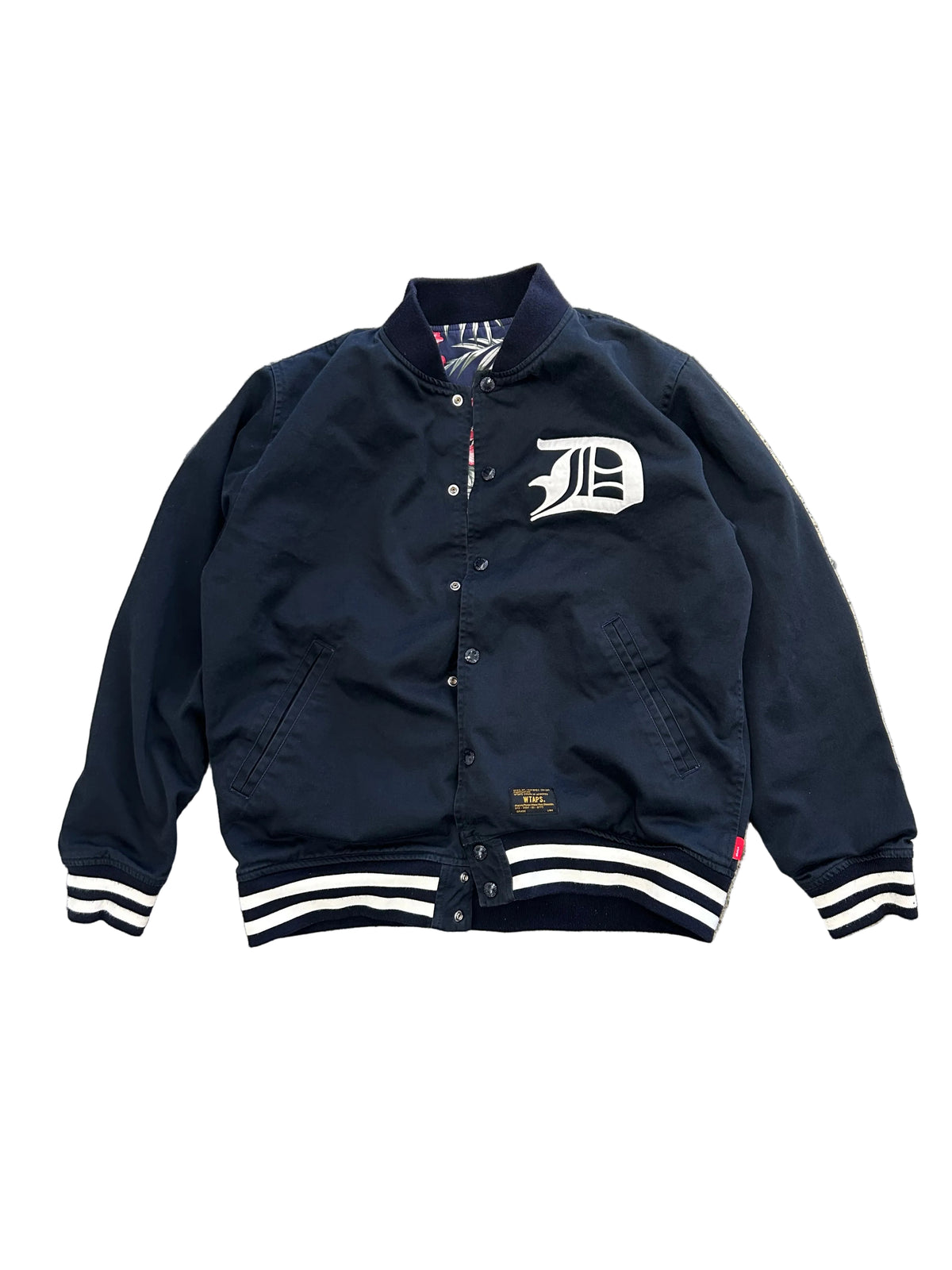 WTAPS 15SS Team Reversible Jacket (often called the Team JKT), featuring a Detroit Tigers-style "D" logo on the chest and a reversible floral/hibiscus lining Large