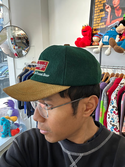 vintage Steinlager two-tone cap featuring a dark green crown and a contrasting tan brim