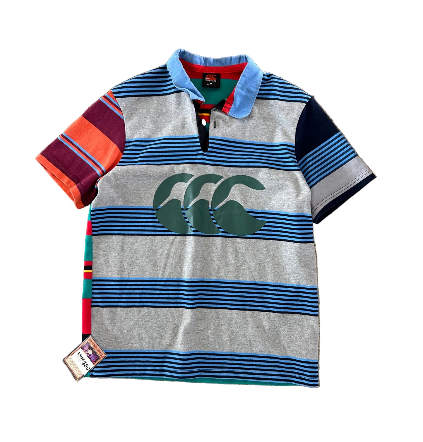 Canterbury of New Zealand short-sleeve rugby jersey features a distinctive multicolored striped design with a large logo