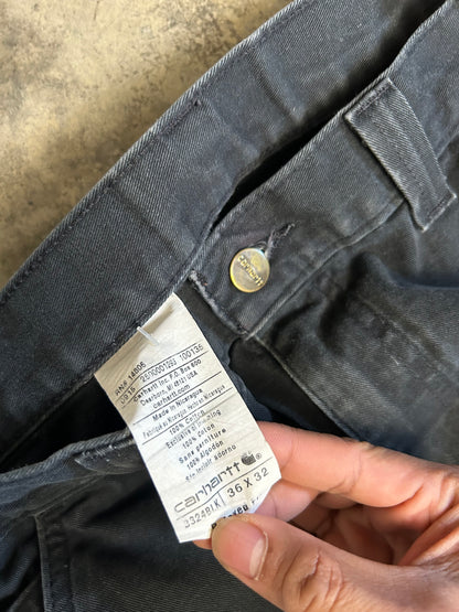 vintage Carhartt Carpenter pants, characterized by a faded black finish and utility features like a hammer loop size 36