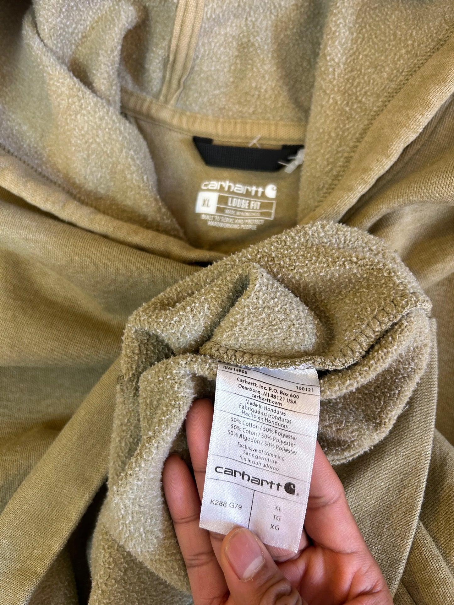 olive Carhartt K288 hooded sweatshirt features a "Carhartt" graphic printed down the left sleeve XL