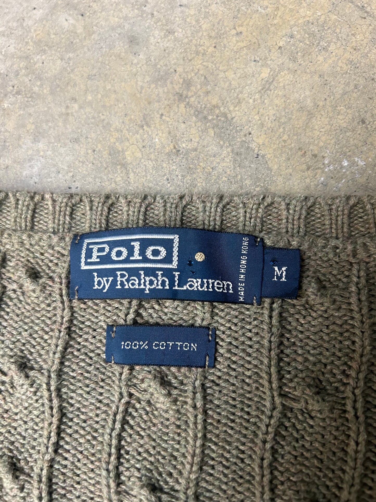 Vintage  Polo Ralph Lauren cable-knit V-neck sweater features a classic olive green textured weave and an embroidered signature pony logo