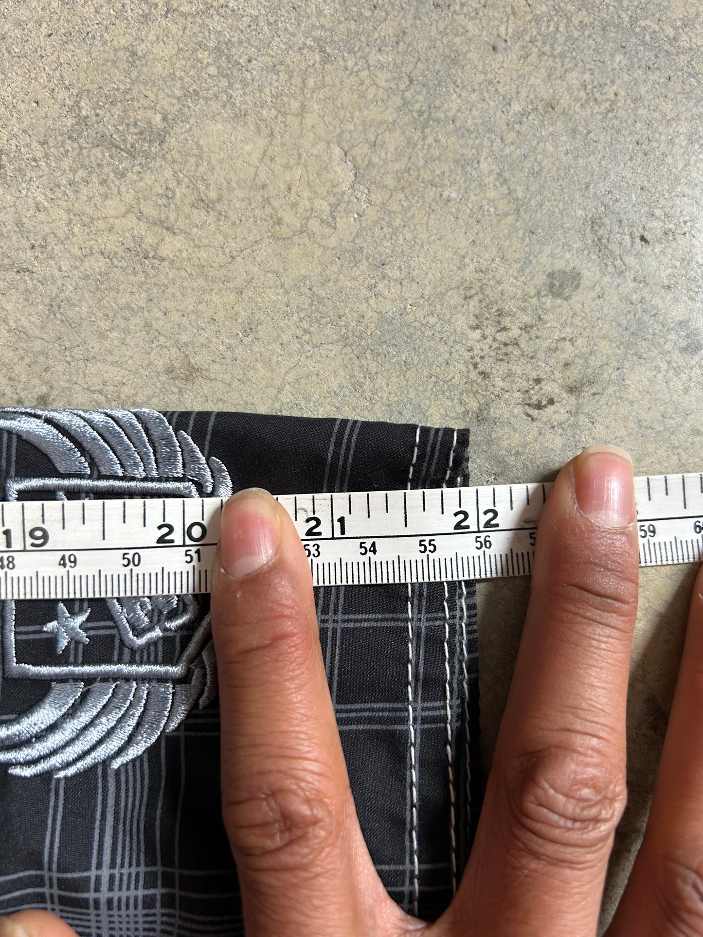 2000s Billabong black and grey plaid board shorts featuring a large embroidered logo on the back 32