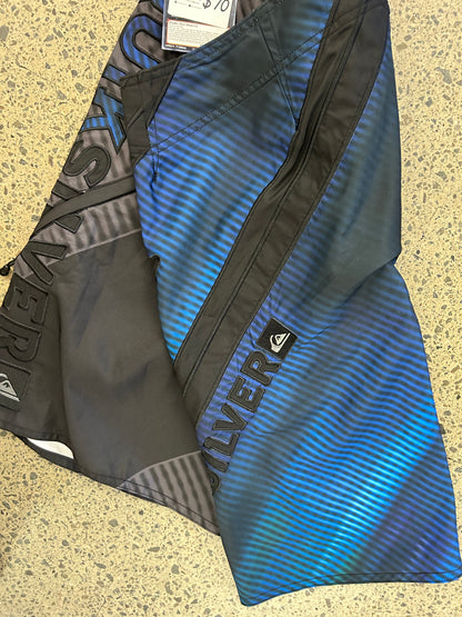 Quiksilver board shorts featuring a black and blue design with diagonal striped detailing size 32