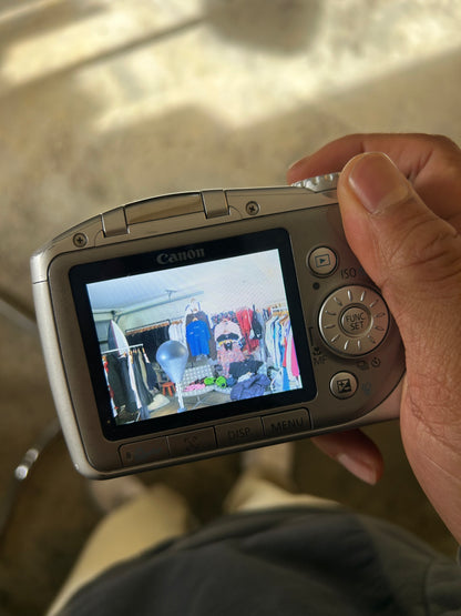 silver Canon PowerShot SX100 IS digital camera with a 10x optical zoom lens