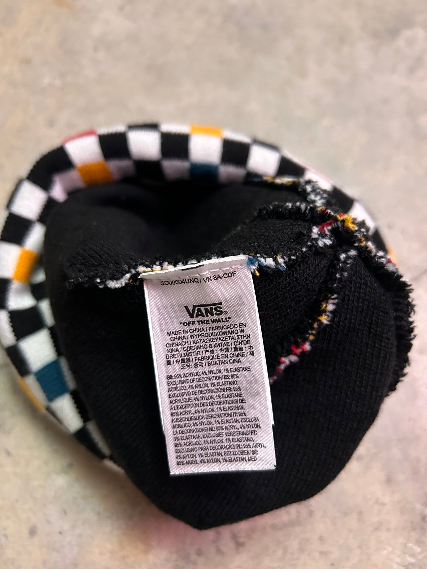 Vans Breakin Out Beanie features a multi-colored checkerboard pattern and a fold-over cuff with the iconic "Off The Wall" label