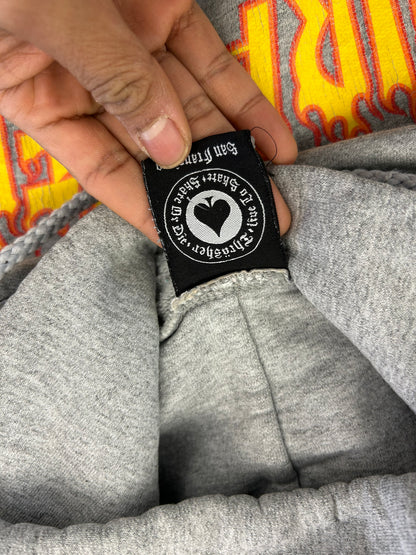 heather grey Thrasher hoodie features the brand's iconic yellow and red flame logo printed across the chest Small