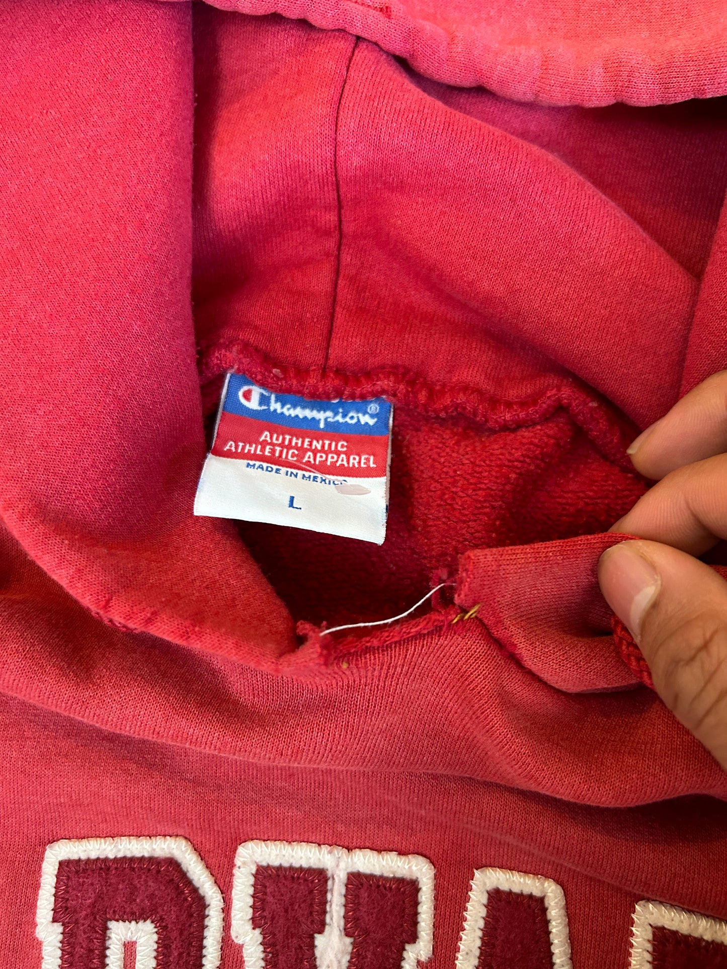 Vintage Fade red Champion hoodie features a prominent arched "HARVARD" spellout graphic and a comfortable kangaroo pocket Large