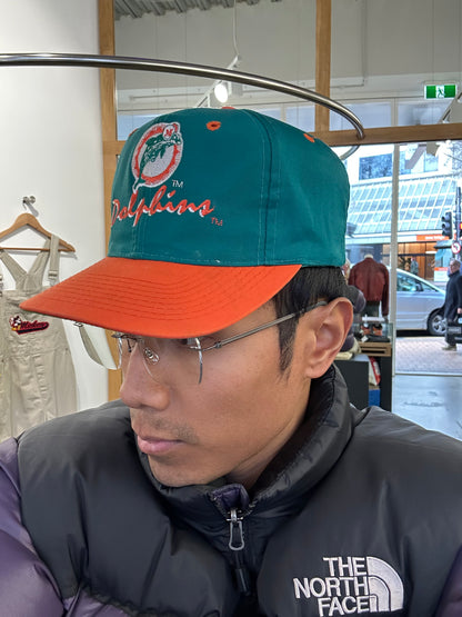 vintage Miami Dolphins snapback hat features a distinctive orange brim contrasting with a teal crown