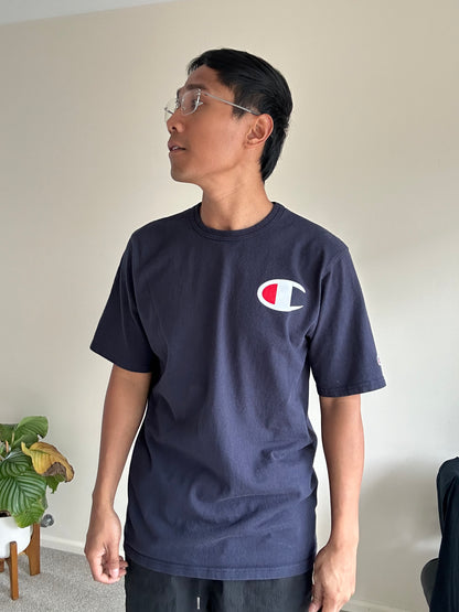 Champion Navy cotton t-shirt with a large C logo on the chest and a  logo on the sleeve Large