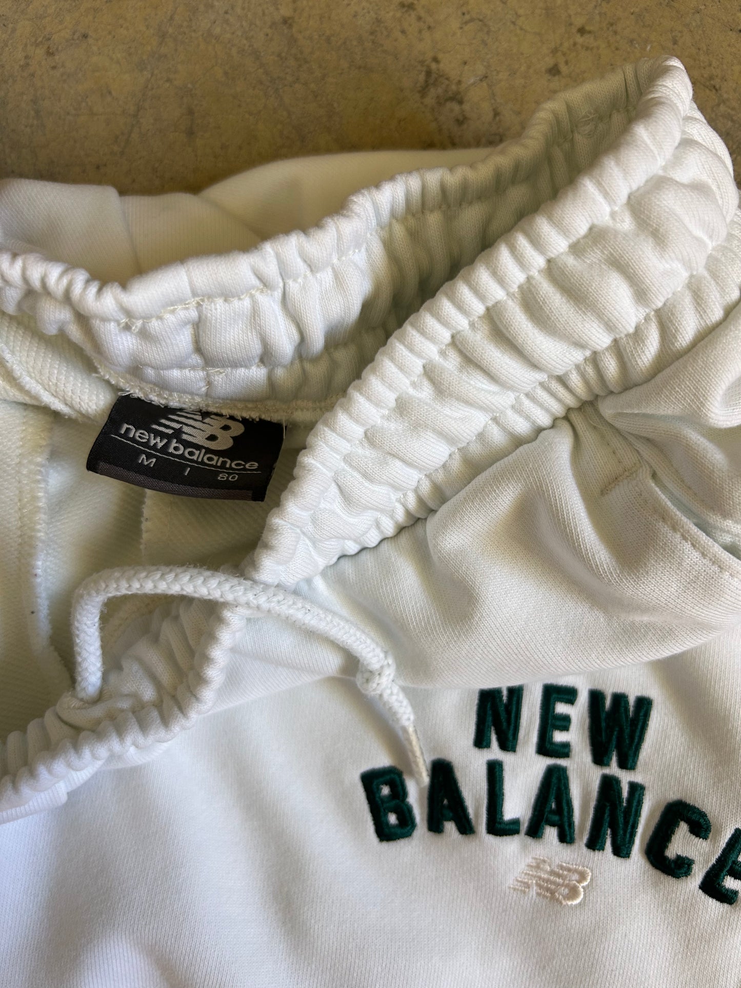 New Balance Essentials Varsity Fleece Sweatpants in a white colorway Medium