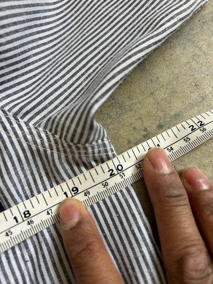 short-sleeve button-up shirt from the brand Stüssy, featuring a classic hickory stripe pattern and dual chest pockets.Medium