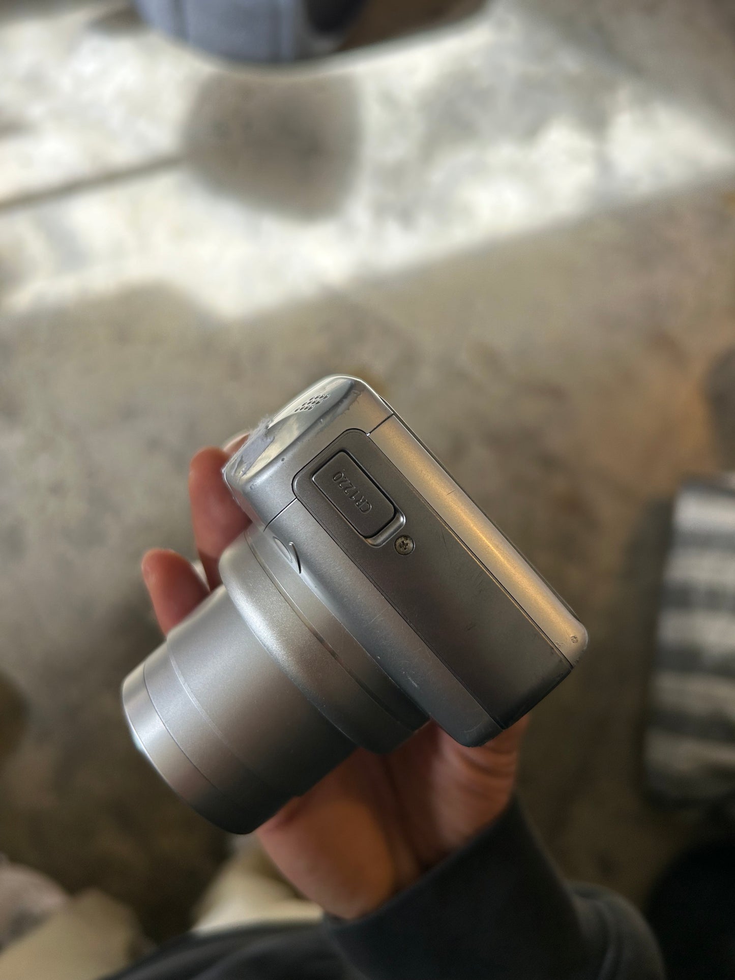 silver Canon PowerShot SX100 IS digital camera with a 10x optical zoom lens